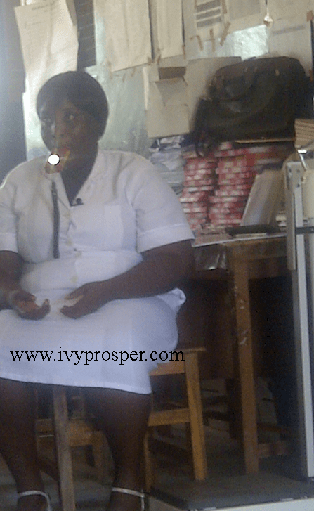 Midwife in Kpalbe, Northern Region of Ghana, demonstrates using flashlight in her mouth. 